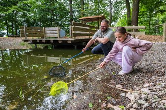 Wo Kinder im Erzgebirgswald die Natur entdecken: Viel Neues am Waldschulheim Conradswiese - Am Waldschulheim Conradswiese hat sich viel verändert. So ist ein neuer Lehrpfad entstanden mit einem Teich, wo man erforschen kann, was alles so im Wasser lebt. Das probieren Herbergsleiter Michael Pfalz und Frieda vom Evangelischen Schulzentrum Muldental aus.