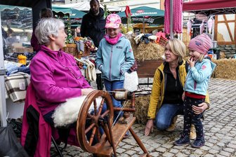 Wo sich noch das Spinnrad dreht: Bauernmarkt in Annaberg ein Ort zum Entdecken - Viel zu entdecken auf dem Herbstmarkt gab es für Famile Nestler und andere bei Gerlinde Theumer am Spinnrad.