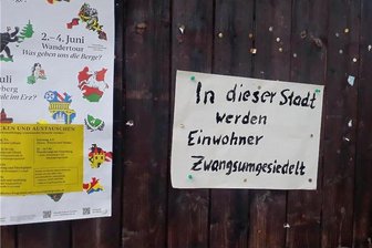 "Zwangsumsiedlung": Abriss von Häusern sorgt im Erzgebirge für Ärger - Eines der Plakate an einer öffentlichen Anschlagtafel in Johanngeorgenstadt. Die Stadtverwaltung lässt sie nach Entdeckung umgehend abnehmen. Ein Spiel, das seit Wochen andauert.
