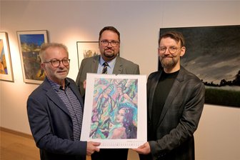 Zwickau: Kunst triff Energie – ZEV-Kalender für 2025 vorgestellt - Wolfgang Schinko, 1. Vorsitzender des Kunstvereins Zwickau, Finanzbürgermeister Sebastian Lasch und Dominik Wirth, Kaufmännischer Geschäftsführer der ZEV (v. l.) mit dem Kunstkalender 2025.