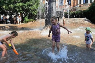 Zwickau schwitzt - Spielende Kinder im Brunnen auf dem Zwickauer Schumannplatz: Ihre Eltern erzählen, dass sie gern auf dieses öffentliche Wasserspiel ausweichen, weil die Bäder in und um Zwickau so voll sind. 